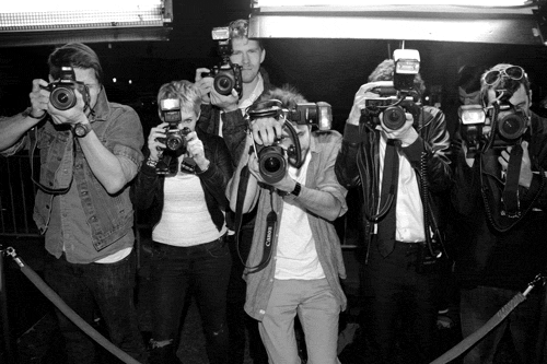 Paparazzi taking photos.