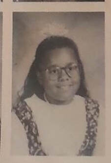 Black and white yearbook photo of Denise as a child