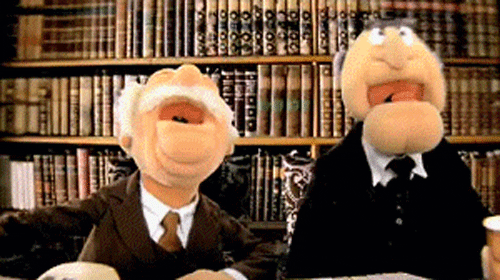 Two old man muppets laughing.