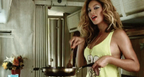 Woman stirring food in pan.